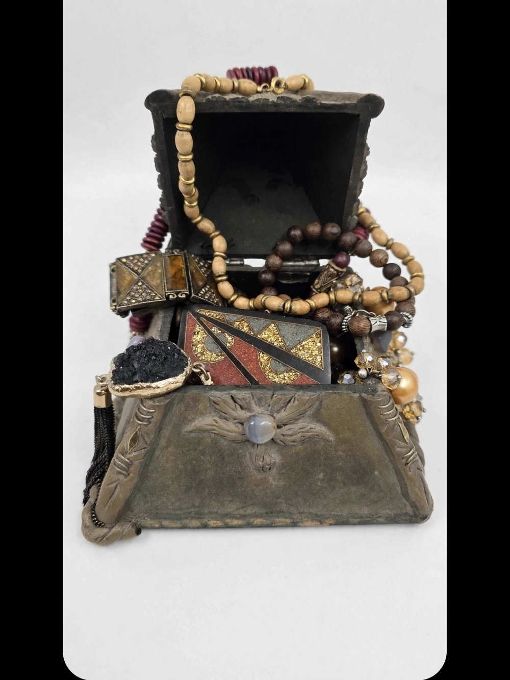 A vintage, handmade, or artisanal novelty trinket box Filled With Jewelry